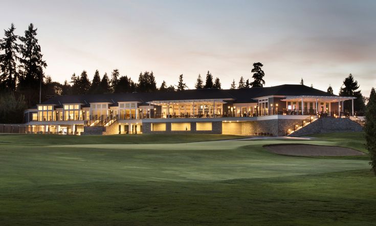 a golf course with a large building in the background