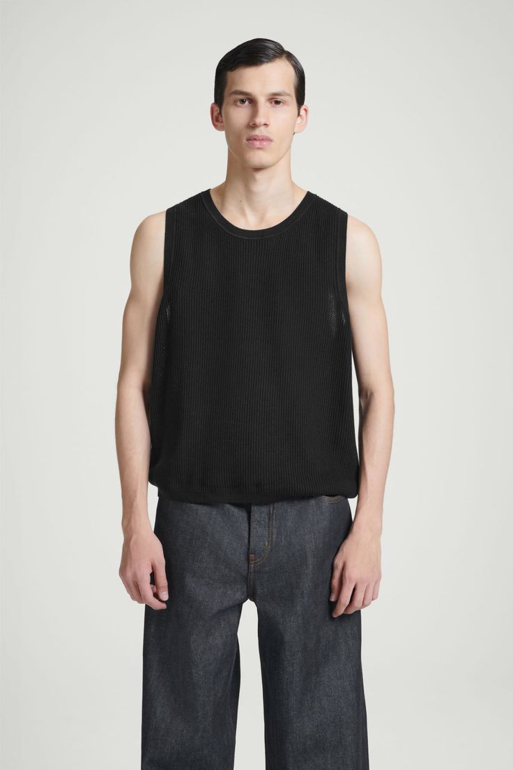 The COS menswear team have been creating elevated wardrobe essentials since the beginning. This upgraded sweater tank is testament to that ethos – designed for a relaxed fit, it's been knitted using a racking stitch that gives the organic cotton fabric a beautifully intricate texture. Wear it with a simple chain hanging over the crew neckline. Round neckSleeveless, tubular trimsOrganic cotton is grown from non-genetically modified seeds without chemical fertilizers or pesticides Shell: 100% Orga Black Knit Streetwear Tops, Relaxed Fit Cotton Crew Neck Sweater Vest, Casual Crew Neck Sweater Vest Relaxed Fit, Cotton Knit Tops For Streetwear, Relaxed Fit Cotton Sweater Vest For Layering, Sleeveless Knit Tops With Relaxed Fit, Cos Menswear, Simple Chain, Cotton Vest