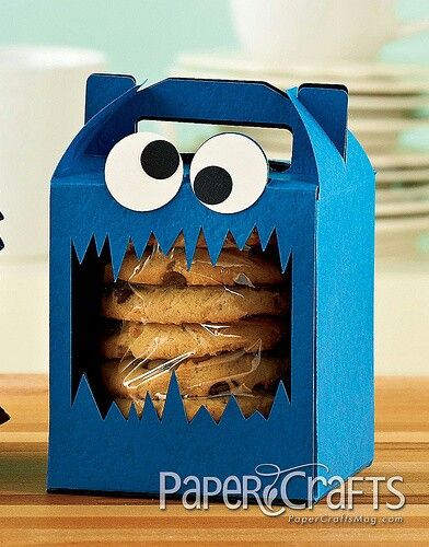 a cookie box with cookies in the shape of a monster's mouth and eyes