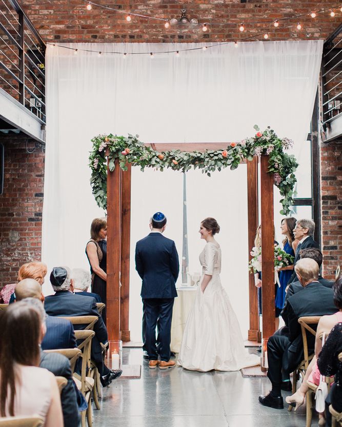 a bride and groom standing at the end of their wedding ceremony