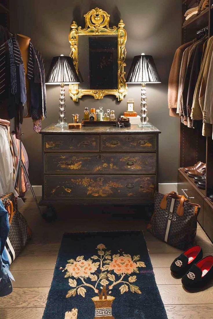 a bedroom with a dresser, mirror and shoes on the floor in front of it