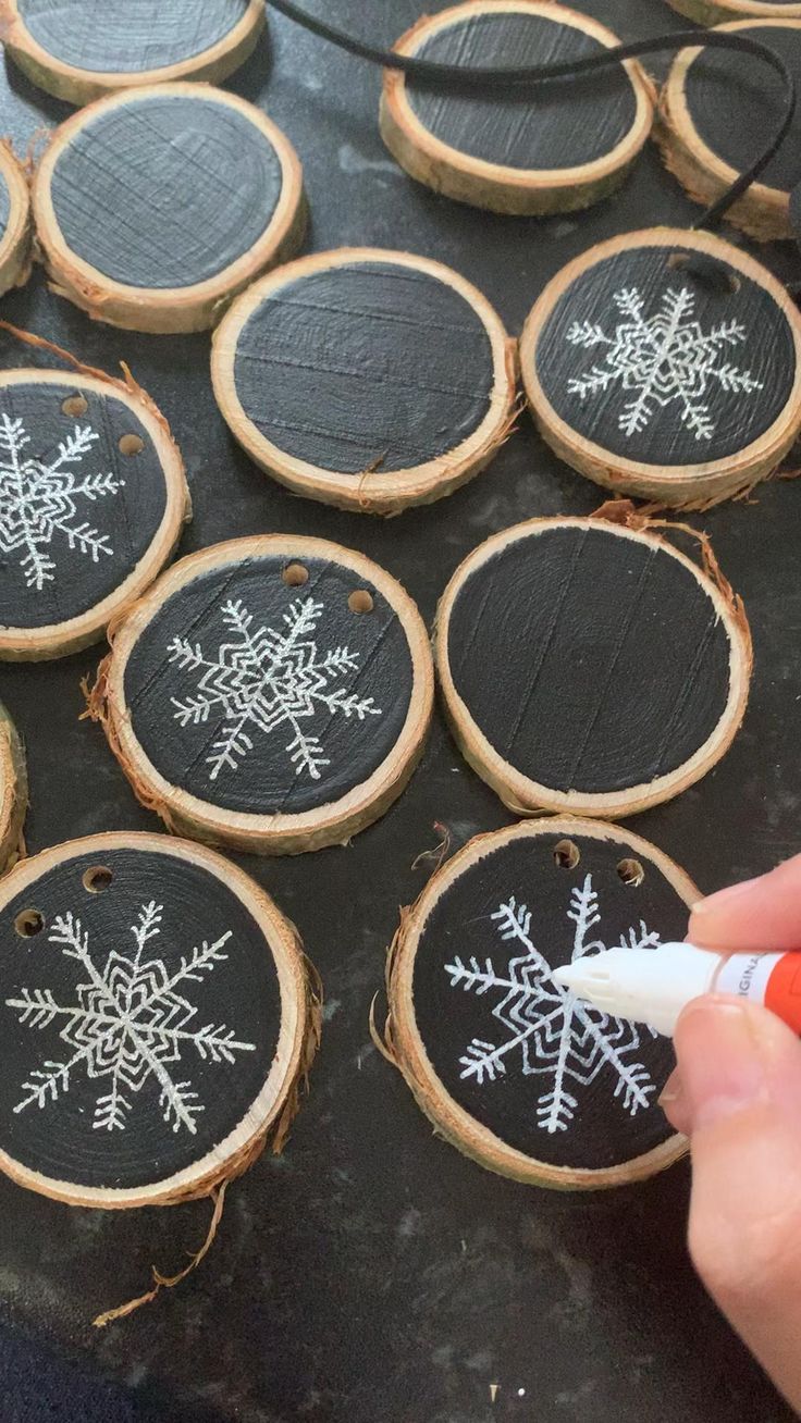 hand painted snowflakes on wood slices are being displayed for the guests to use