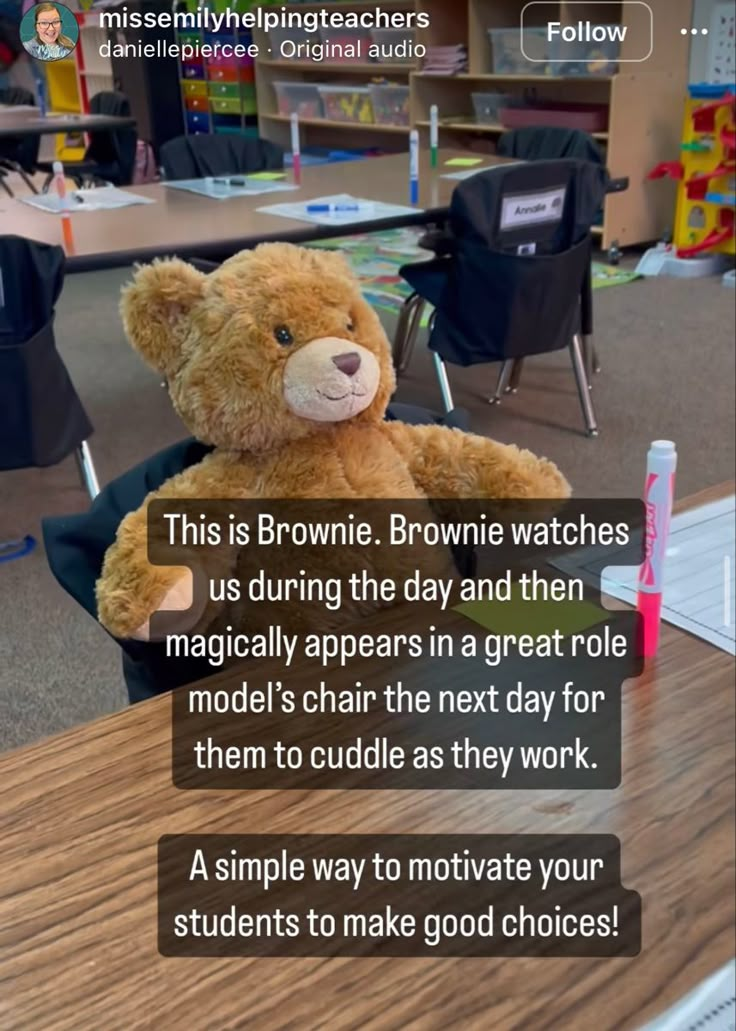 a brown teddy bear sitting on top of a wooden table