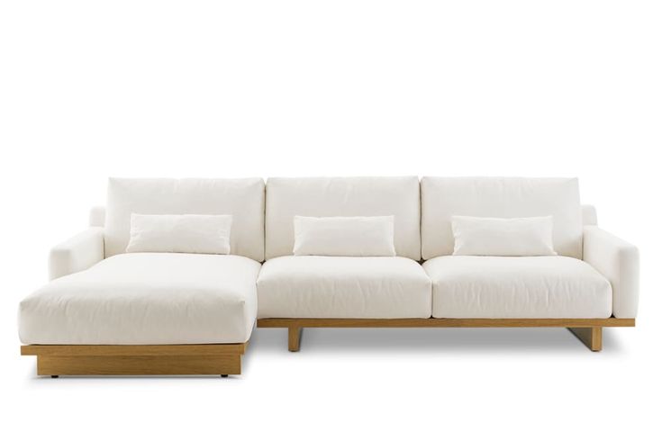 a white couch sitting on top of a wooden frame