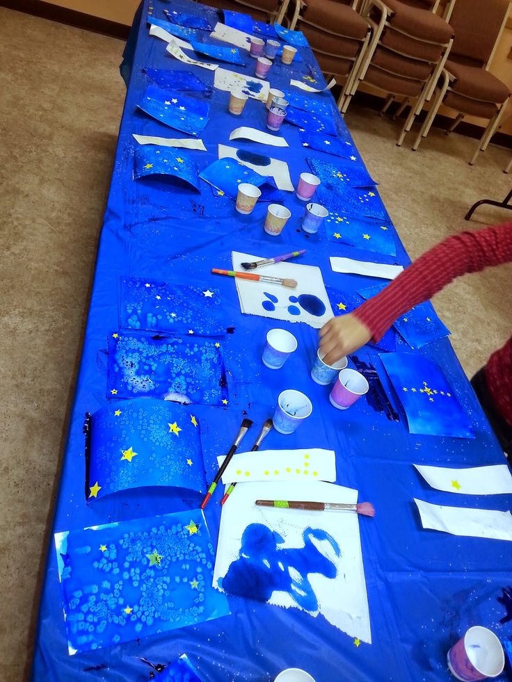 a table covered in blue paper and paint