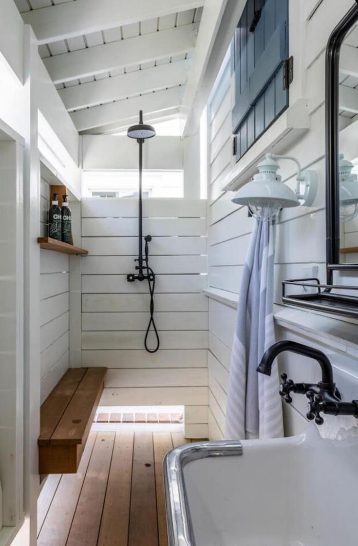 a bathroom with wood floors and white walls