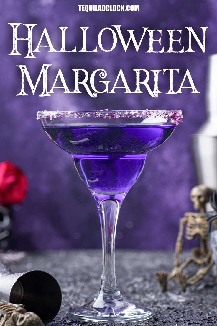 a purple cocktail in a coupe glass with the words halloween margarita on it and skeleton decorations