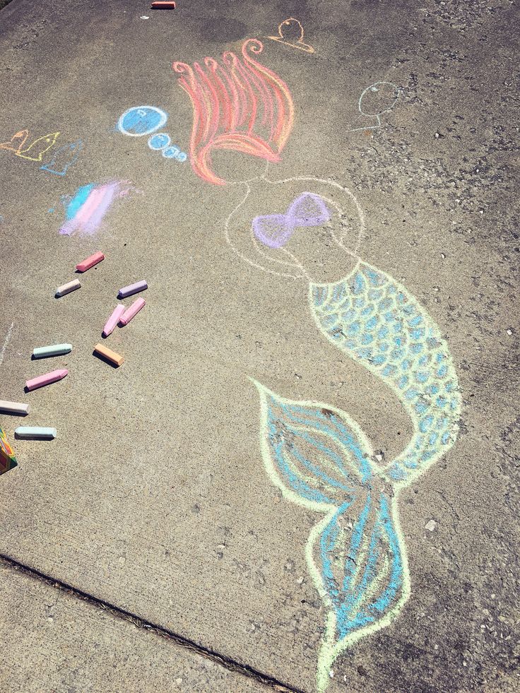 some chalk drawings on the ground with crayons