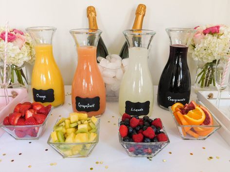 a table topped with bottles of champagne and fruit