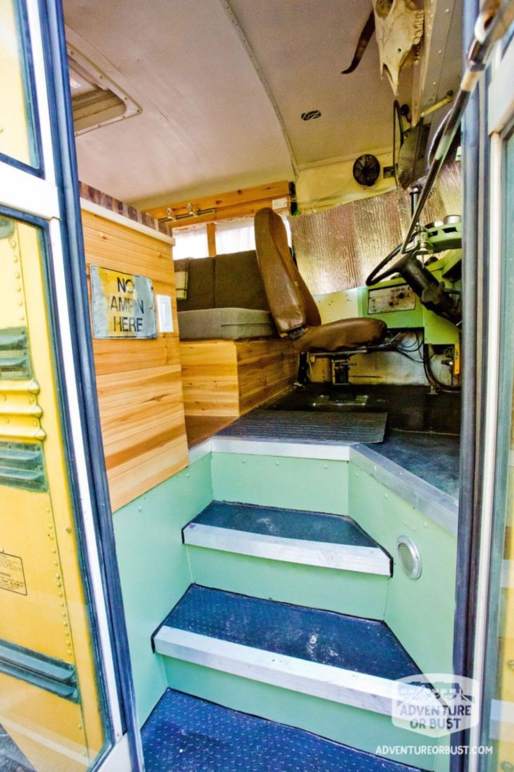 the interior of an old bus with blue steps