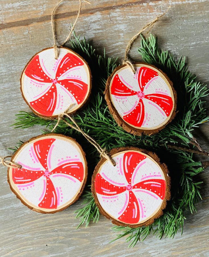 three christmas ornaments made out of wood and decorated with red and white candy canes