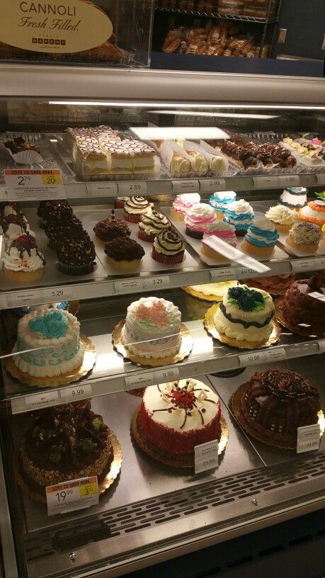 a display case filled with lots of different types of cakes