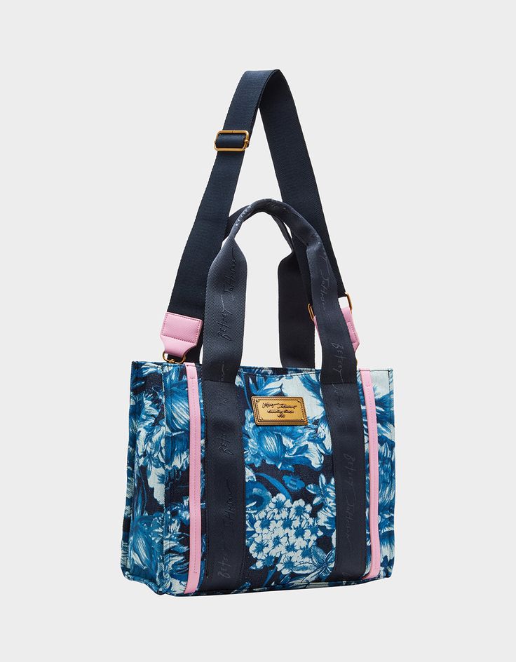 Get ready to tote around your essentials in style with our SMALL DENIM TOTE BLUE! This quirky and fun bag features a blue floral design, perfect for adding a pop of color to any outfit. Plus, with the convenient crossbody strap, you can easily carry it while on the go. Manmade & textile denim materials 13"L x 6"D x 11"H Imported Casual Blue Shoulder Bag With Floral Print, Casual Blue Shoulder Bag With Handles, Casual Blue Floral Print Shoulder Bag, Blue Canvas Bags With Double Handle, Blue Canvas Double Handle Bag, Trendy Cotton Bags With Floral Print, Blue Double Handle Canvas Bag, Blue Floral Print Shoulder Bag For Everyday, Everyday Blue Floral Print Shoulder Bag