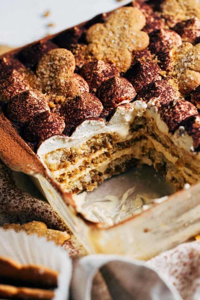 a cake that has been cut in half and is sitting on a table next to other desserts