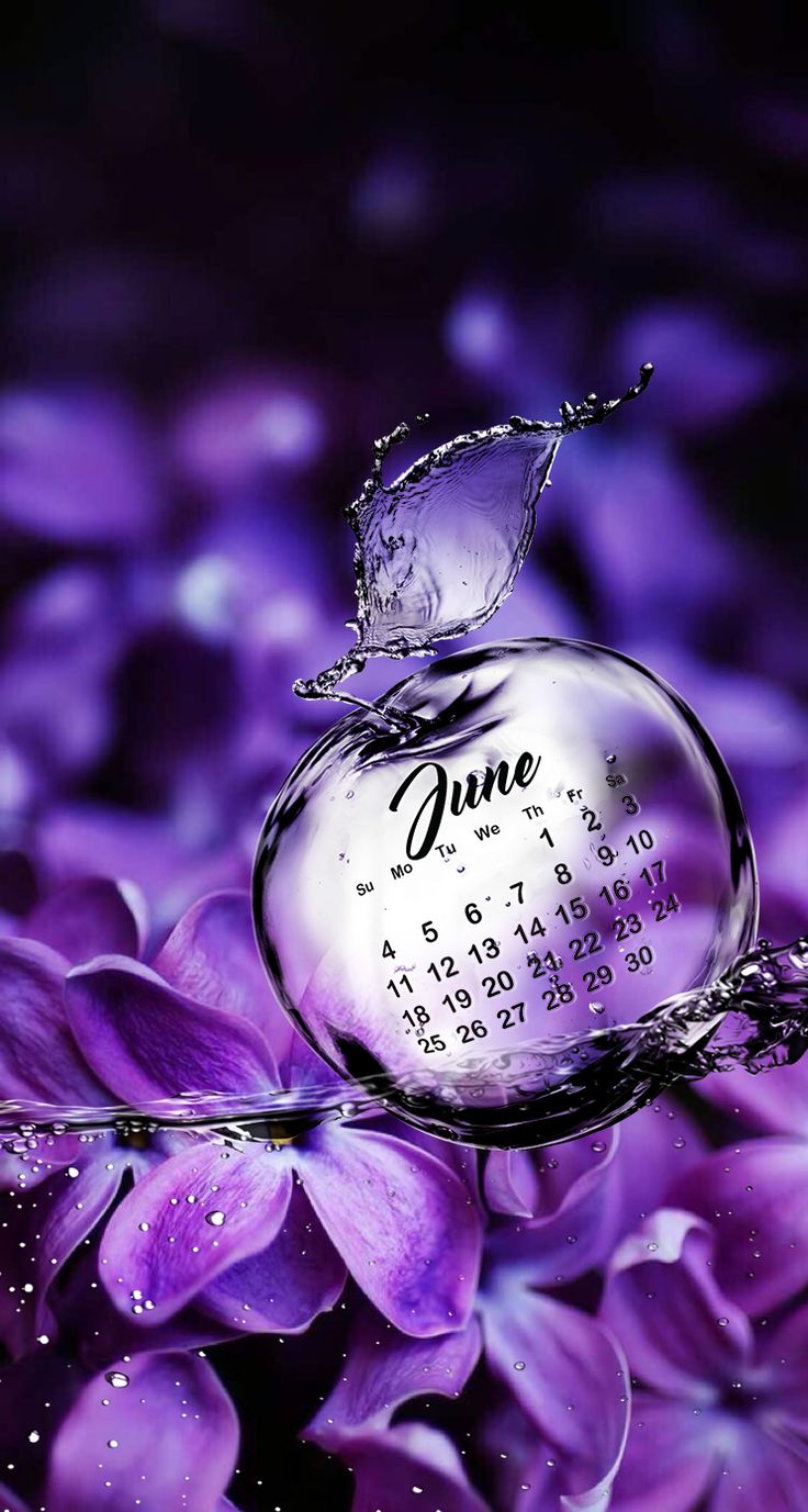 a purple flower with water splashing on it and the word june written in white