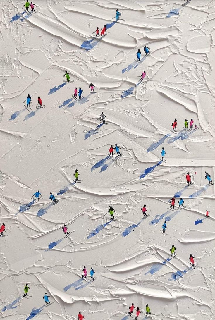 an aerial view of people skiing down a slope