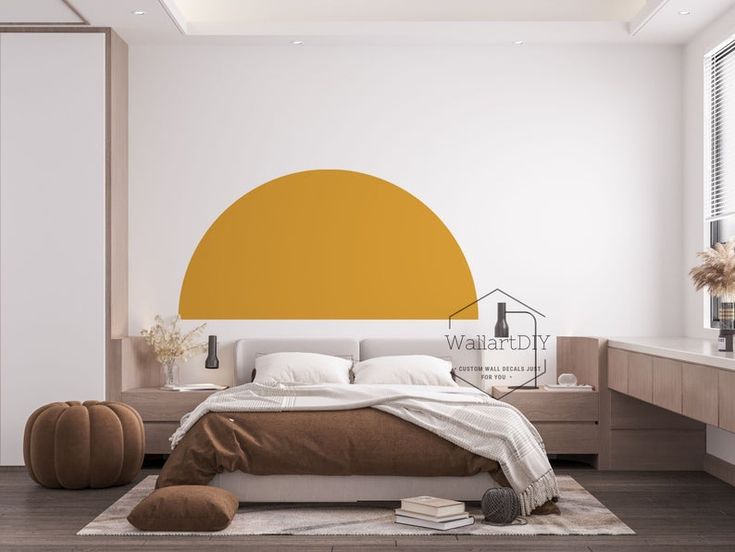 a bed room with a neatly made bed and a large yellow sun decal on the wall