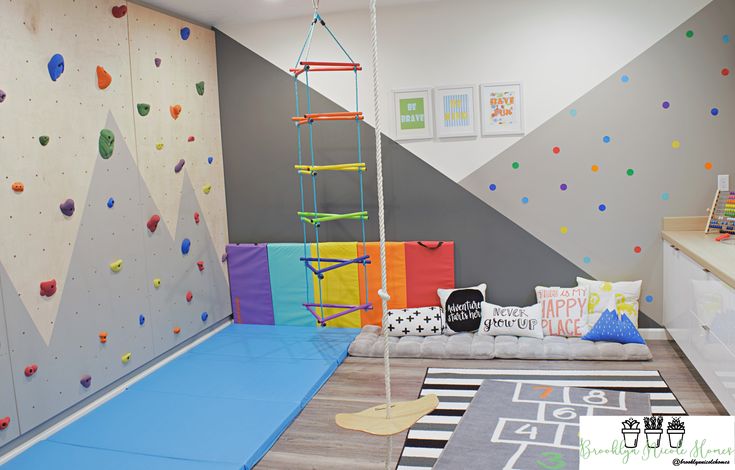 a room with climbing walls and play equipment