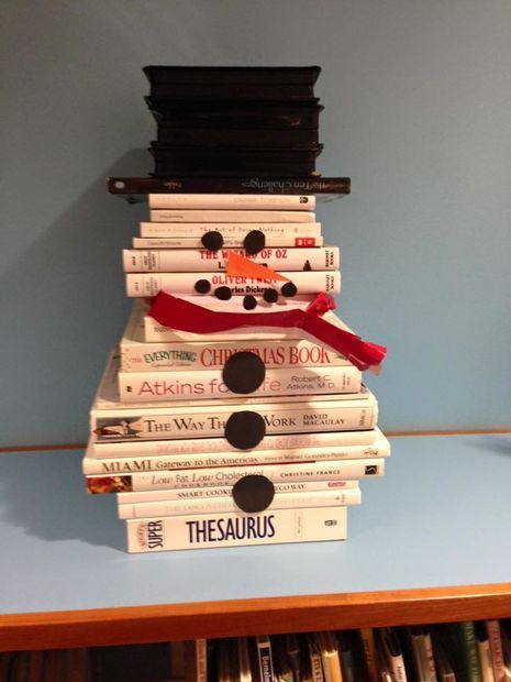 a stack of books stacked on top of each other with a red ribbon around them