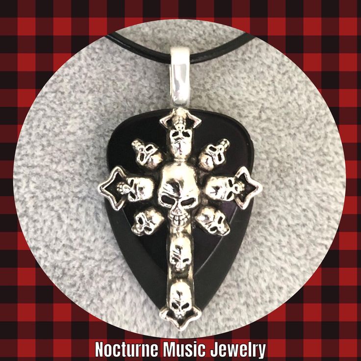 For the love of Goth! 💀 For women and men  Large silver Cross of Skulls Charm on black celluloid and black delrin picks.  Large silver bail.  Solid and sturdy pendant.  Length approx 2 inches.  Style choice:  Stainless Steel Chain 24" Stainless Steel Chain 20" Black leather cord 18" (w/2" ext) Black Jewelry For Halloween Concert, Silver Halloween Concert Jewelry, Silver Jewelry For Halloween Concert, Black Rock Style Jewelry For Halloween, Halloween Rock Concert Jewelry, Rock Style Jewelry For Halloween Concert, Black Rock Style Jewelry For Concerts, Handmade Black Jewelry For Concert, Handmade Black Jewelry For Concerts