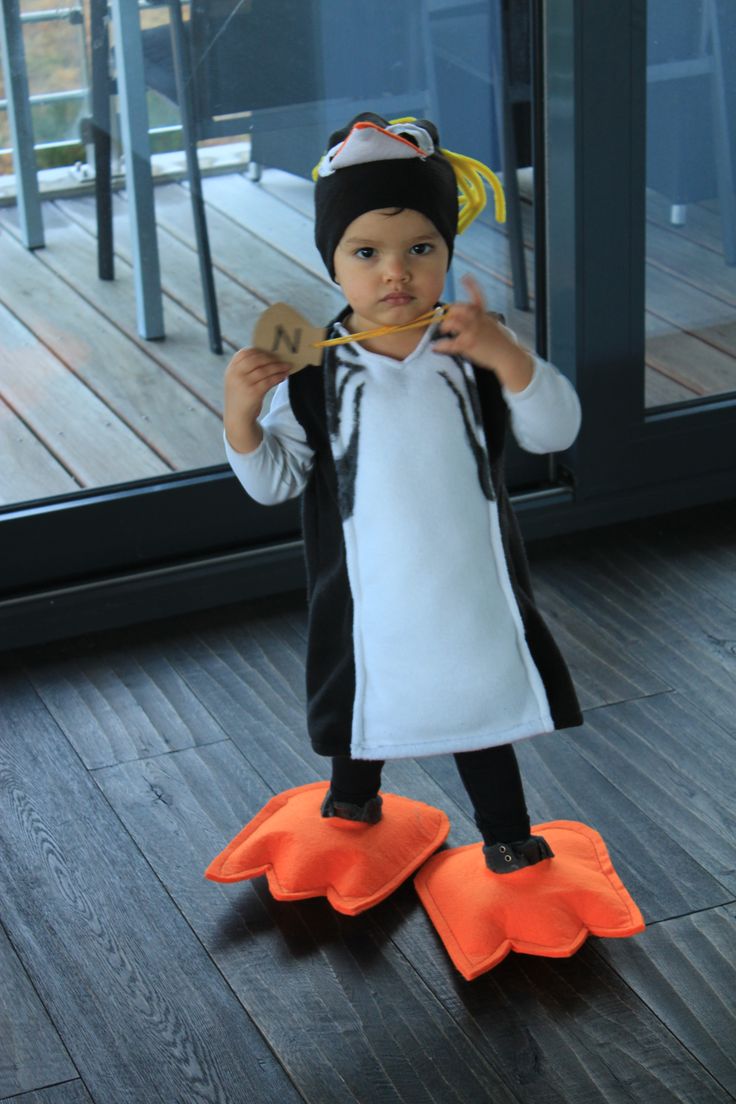 a little boy dressed up like a penguin