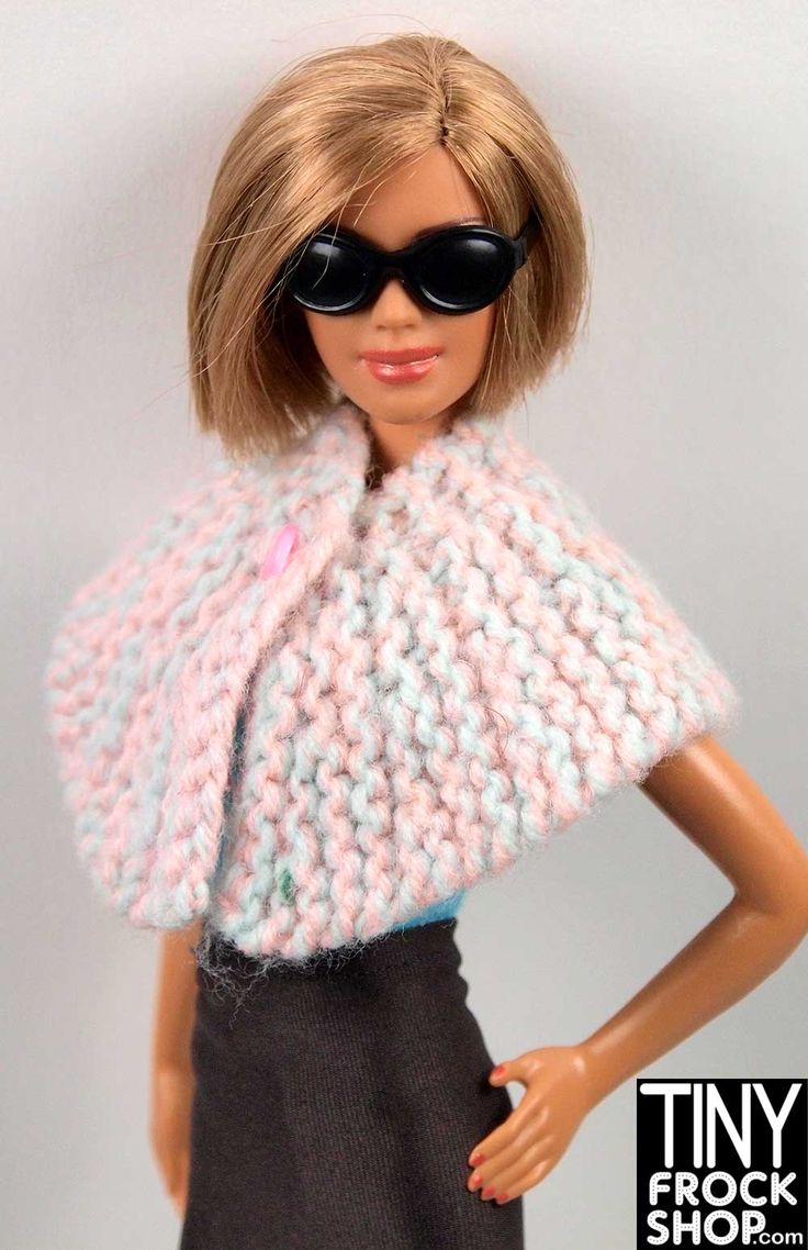 a barbie doll wearing sunglasses and a knitted shawl over her shoulders with the words tiny frock shop on it