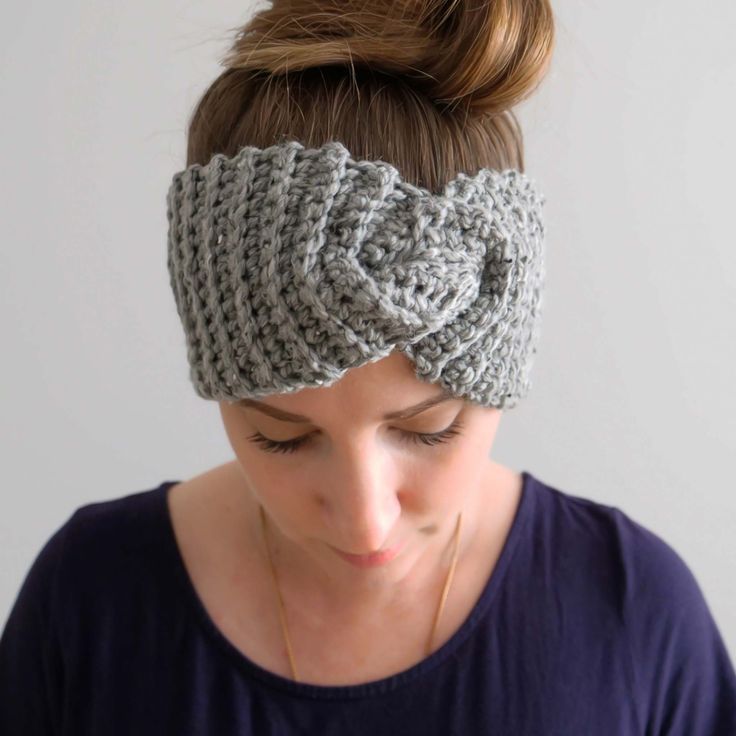 a woman wearing a gray headband with a knot on it