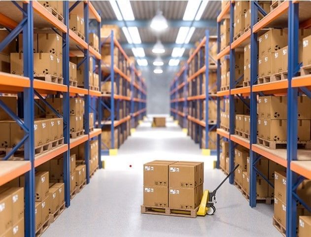 a warehouse filled with lots of boxes and pallet trucks on each side of the aisle