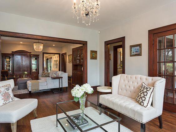 a living room filled with furniture and a chandelier