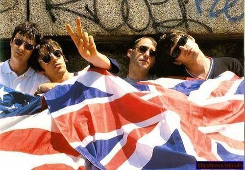 three men with sunglasses on their heads are wrapped in an union jack and white flag