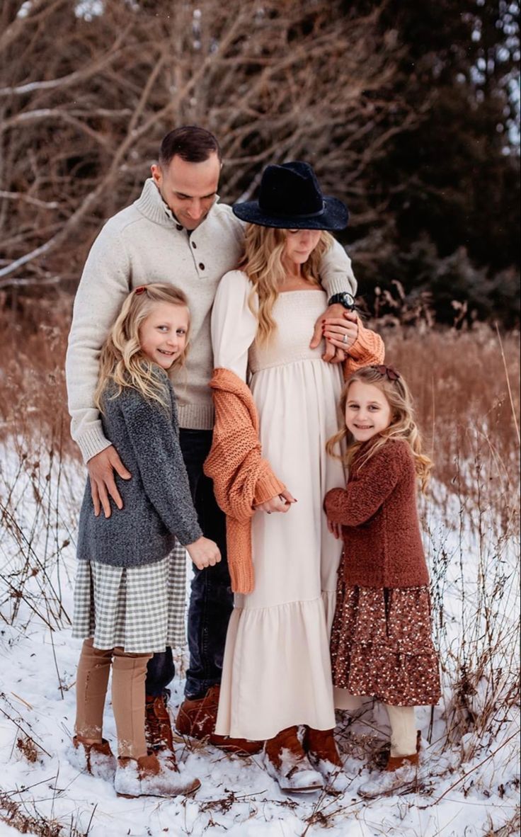 a family standing in the snow together