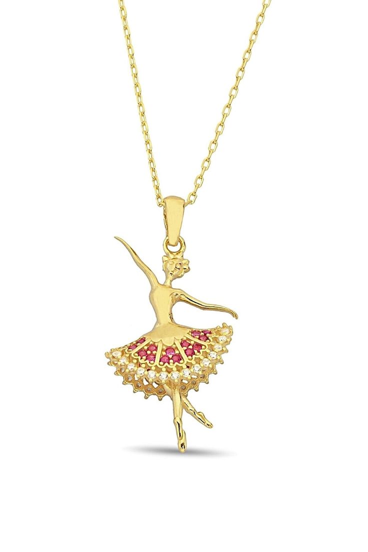 a gold ballerina necklace with red stones on the bottom and a chain attached to it