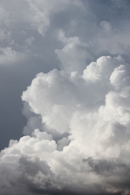 an airplane is flying in the cloudy sky