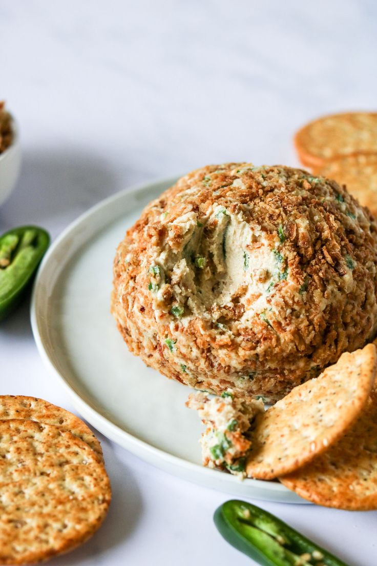 a white plate topped with crackers and a cheese ball