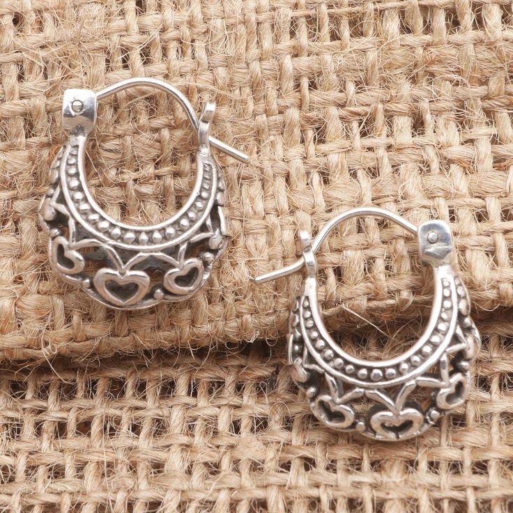 Romance is all around when you wear these petite hoop earrings from Sukartini in Bali. Crafted from sterling silver the hoops are embellished with heart motifs and beaded details. Bohemian Sterling Silver Heart Earrings, Nickel Free Silver Hoop Heart Earrings, Silver Nickel-free Hoop Heart Earrings, Silver Nickel-free Heart Hoop Earrings, Nickel Free Open Heart Hoop Earrings, Nickel Free Small Hoop Silver Heart Earrings, Nickel-free Silver Heart Hoop Earrings, Nickel-free Open Heart Hoop Earrings, Nickel-free Small Hoop Heart Earrings In Silver