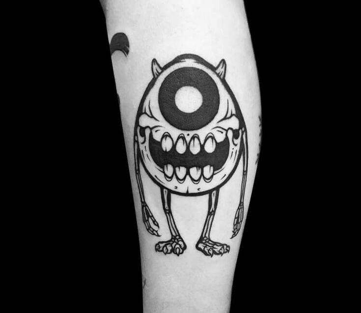 a black and white tattoo with an evil looking monster on it's left leg