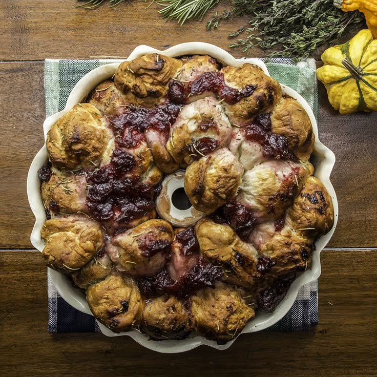 a pie sitting on top of a wooden table covered in cranberry toppings