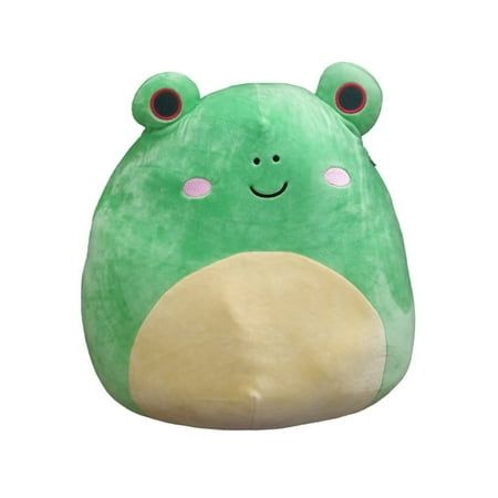 a green stuffed animal sitting on top of a white surface