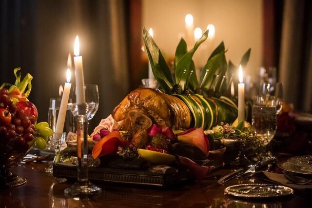 a table is set with candles, fruit and other items for a festive feast