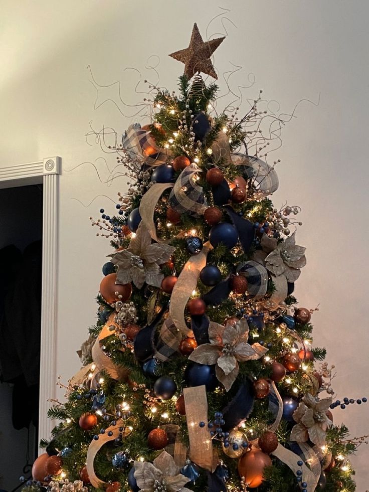 a decorated christmas tree with blue and gold ornaments