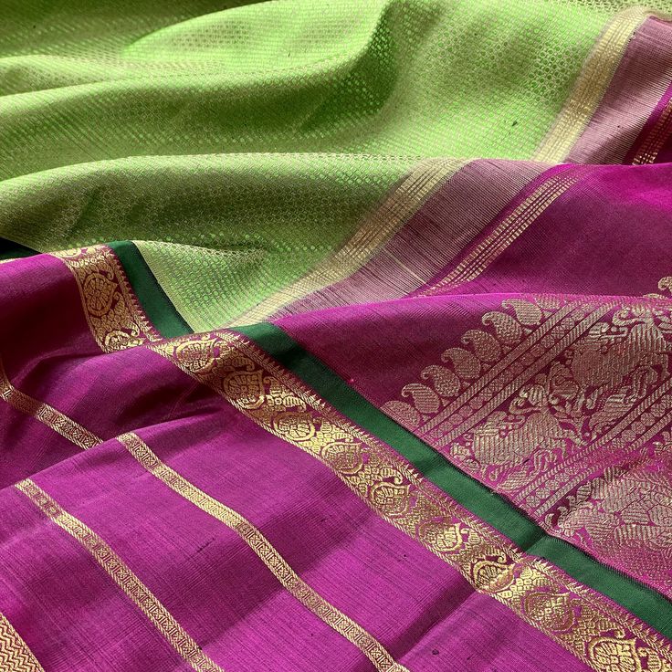 This elegant kanjivaram saree in green woven with muted brown to give a metallic look, is handwoven with korvai borders adorned in deep purple color. The grand pallu mirrors the borders with traditional motifs in gold zari. Approximate Length 6.5 mtrs (inclusive of blouse length)Height - 46 - 52" Saree comes with fall, picot and tassels done when applicable. Blouse piece is cut. Approximate weight - 1.8 lbs Kindly Note : The colors you see on your device may vary due to the color reproduction, b Green Tissue Silk Pre-draped Saree With Zari Weaving, Luxury Tussar Silk Pre-draped Saree With Zari Weaving, Green Pre-draped Tussar Silk Saree With Zari Weaving, Green Tussar Silk Pre-draped Saree Handloom, Festive Purple Tussar Silk Pre-draped Saree, Muted Brown, Kanjivaram Saree, Kanjivaram Silk Saree, Deep Purple Color