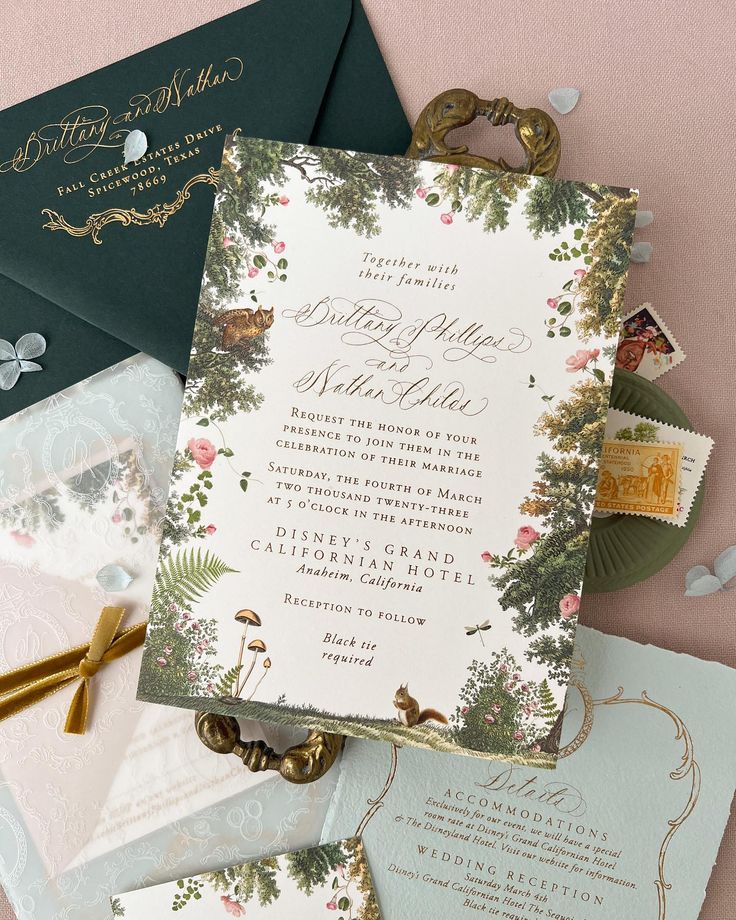 the wedding stationery is laid out on top of each other, including envelopes