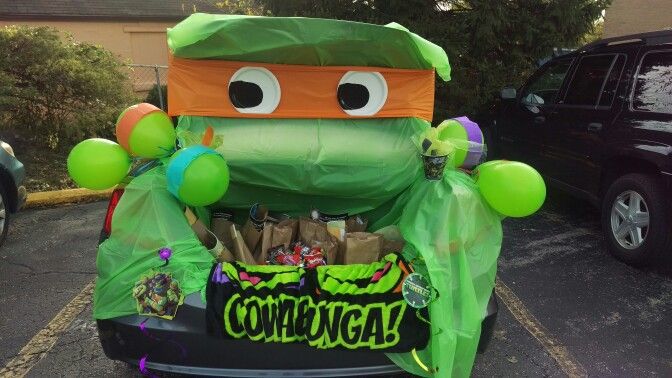 an inflatable car decorated with balloons and decorations