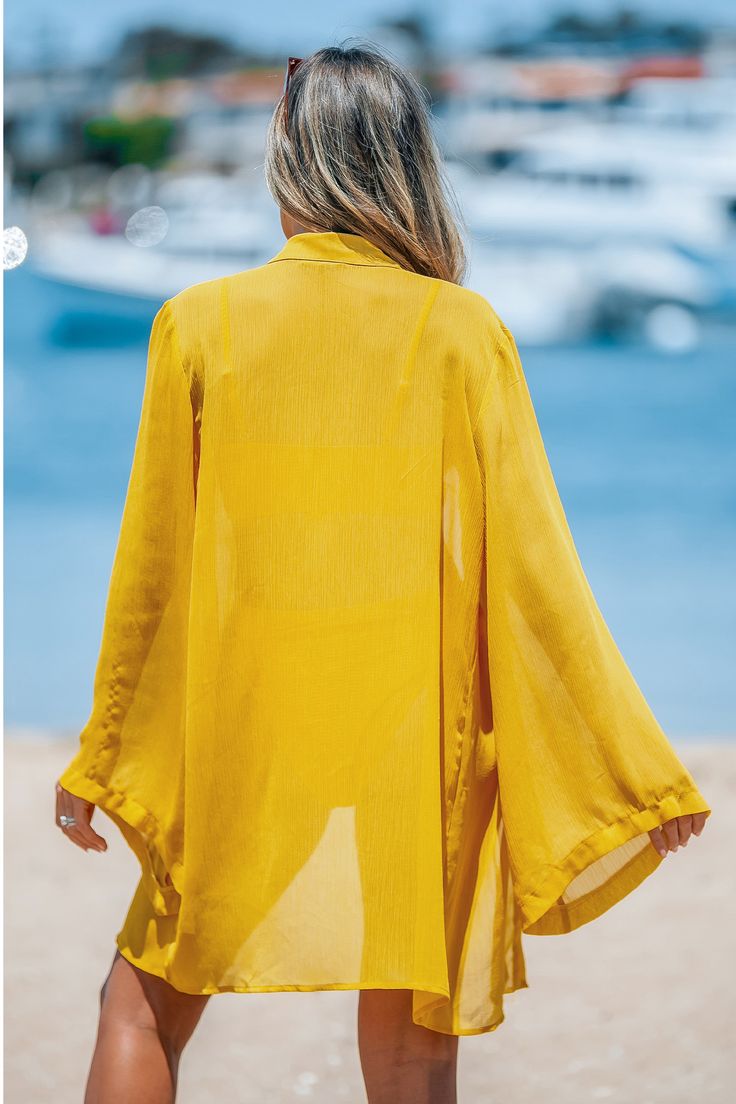 Brighten your beach day with the Yellow Chiffon Open Front Flared Sleeve Cover-Up. This airy piece features flowing flared sleeves and an open front design, perfect for layering over your favorite swimsuit. Product code: CAA07A4D012NN Features:  Woven Collared neckline Open front with tie closure Long flared sleeves Wash Method: Regular Wash Material: 100%POLYESTER. Yellow Long Sleeve Swimwear For Spring, Solid Summer Beach Cover-up, Kimono Sleeve Swimwear For Poolside And Beach Season, Chiffon Kimono For Spring Vacation, Solid Cover-up For Spring Beach Party, Solid Color Cover-up For Spring Beach Party, Solid Color Beach Dress For Spring, Bohemian Solid Color Summer Cover-up, Solid Color Cover-up For Beach Party Season