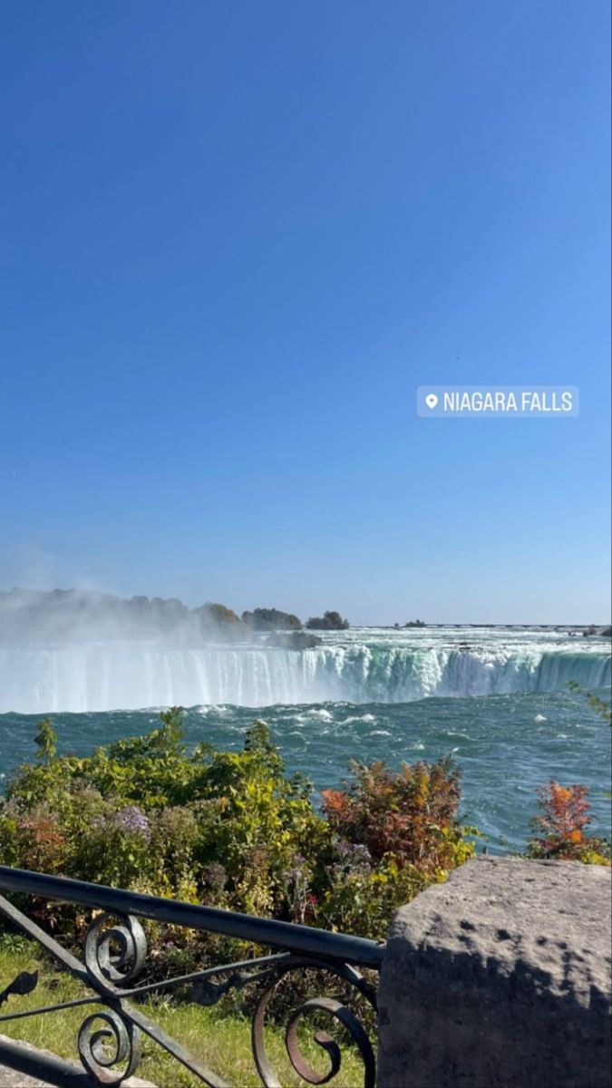 the niagara falls in niagara, canada as seen from across the river on a sunny day