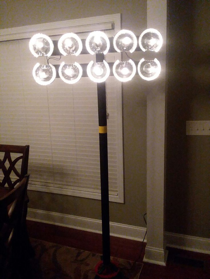 a light that is on top of a pole in the middle of a living room