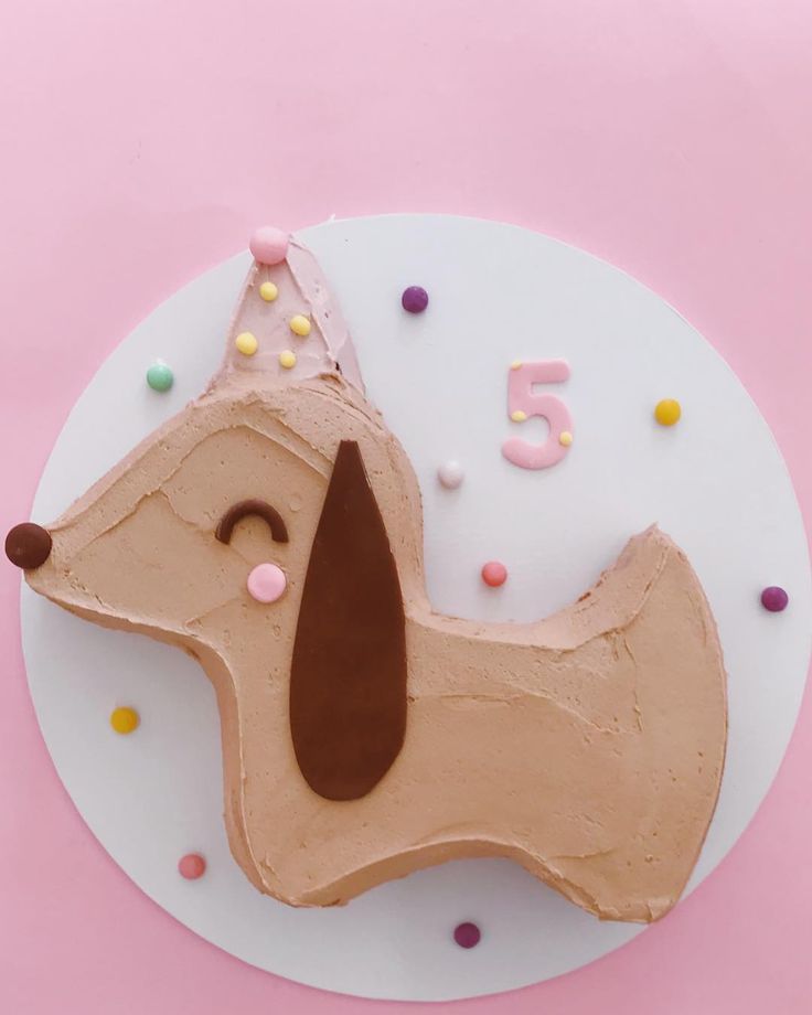 a cake shaped like a dog with sprinkles on it