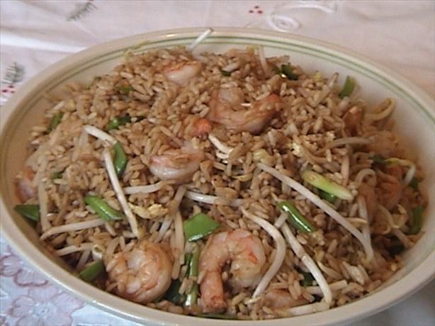 a bowl filled with rice and shrimp on top of a table