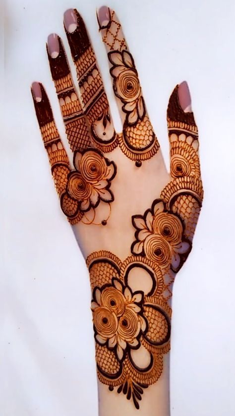 the hand is decorated with henna and flowers