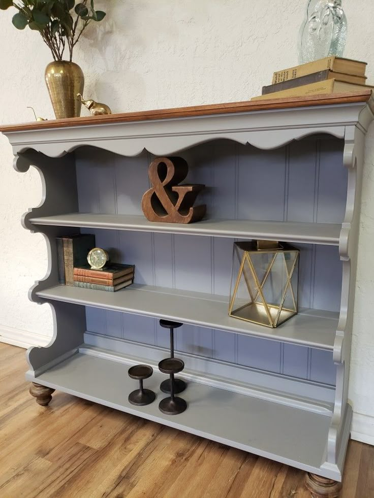 an old bookcase with some candles on it